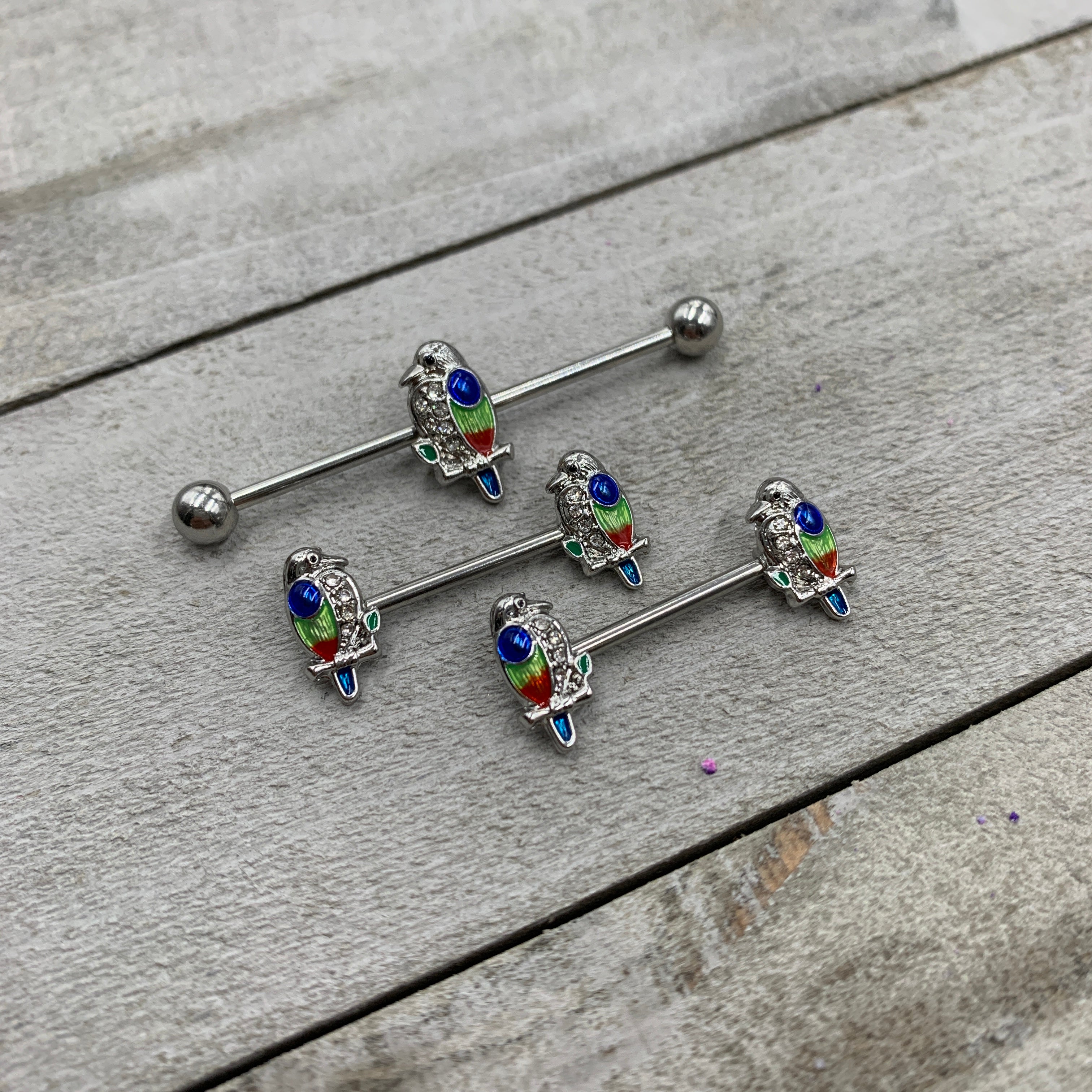 BodyCandy 14G 9/16 Clear Gem Tropical Parrot Bird Barbell Nipple Ring Set — detail close-up