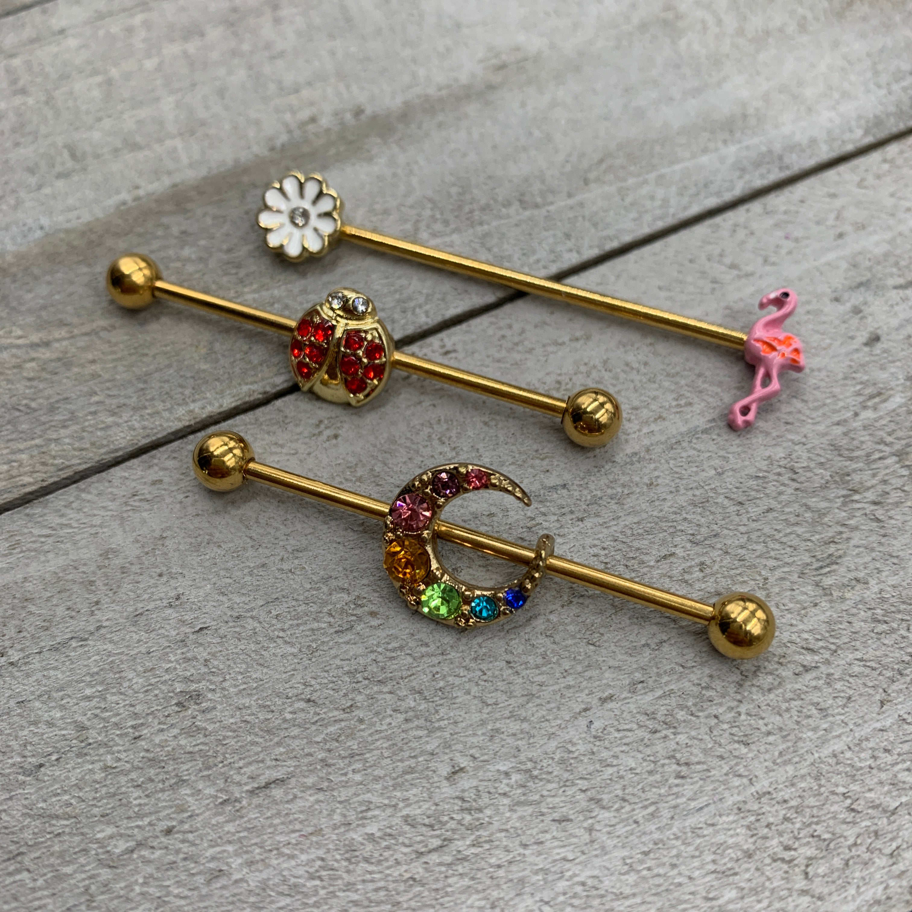 BodyCandy 14G Clear Gem Gold Hue Flower Flamingo Industrial Barbell 38mm — detail close-up