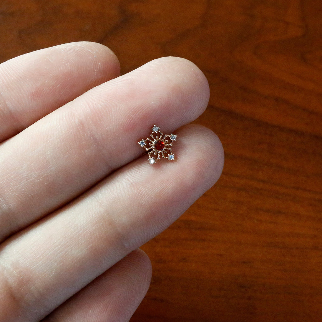 BodyCandy 16G 1/4 Red Gem Rose Gold Tone Texture Snowflake Labret Tragus — in-use photo