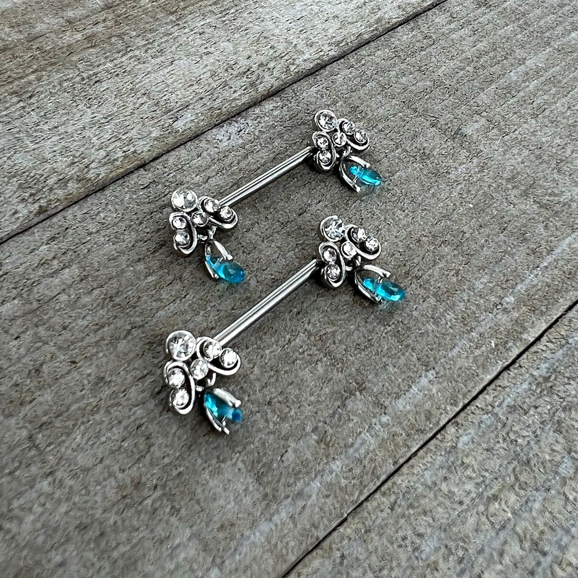 BodyCandy 14G 9/16 Blue Gem Scrolling Elegance Dangle Nipple Ring Set — side view