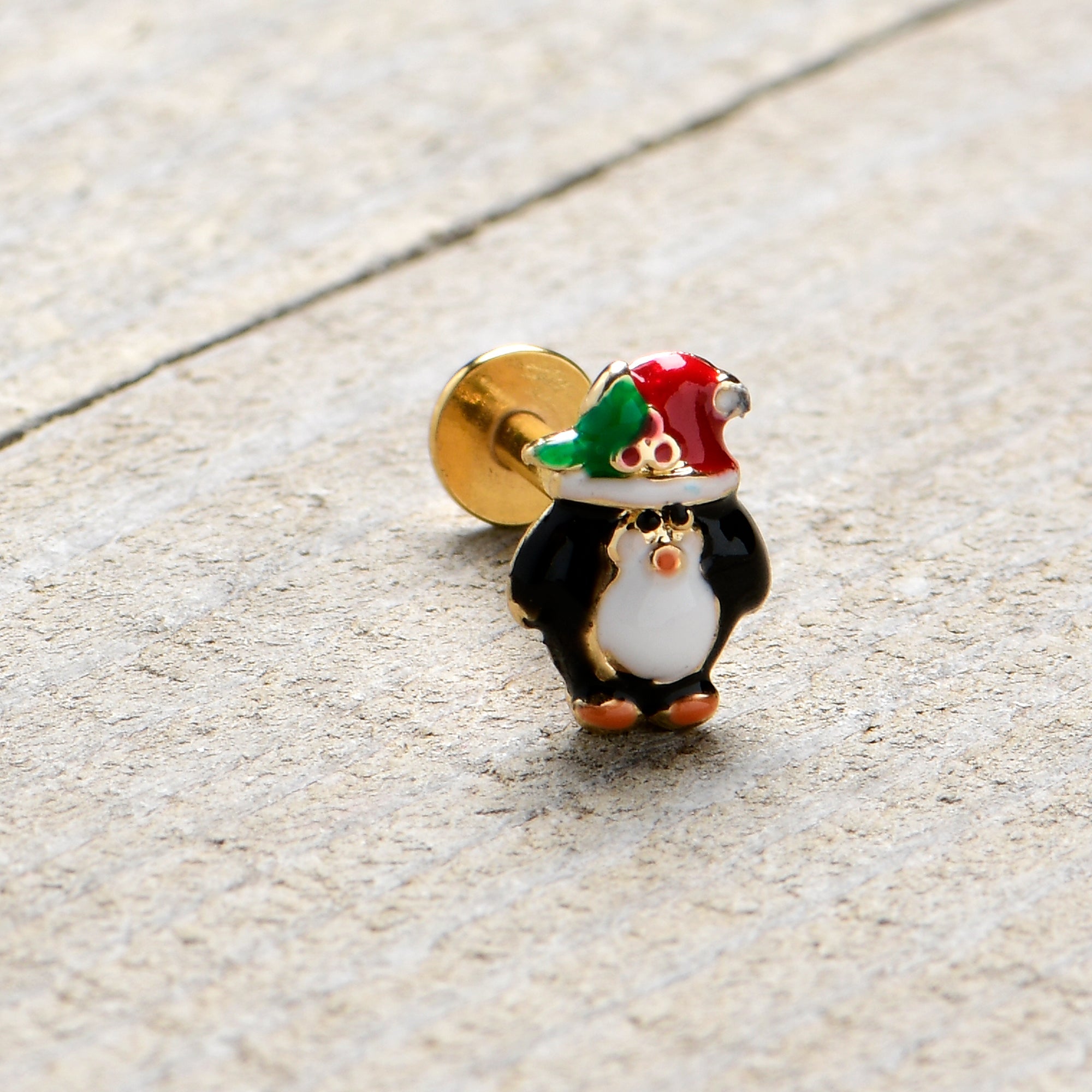 BodyCandy 16G 5/16 Gold Tone Holly Hat Penguin Holiday Labret Monroe Tragus — in-use photo