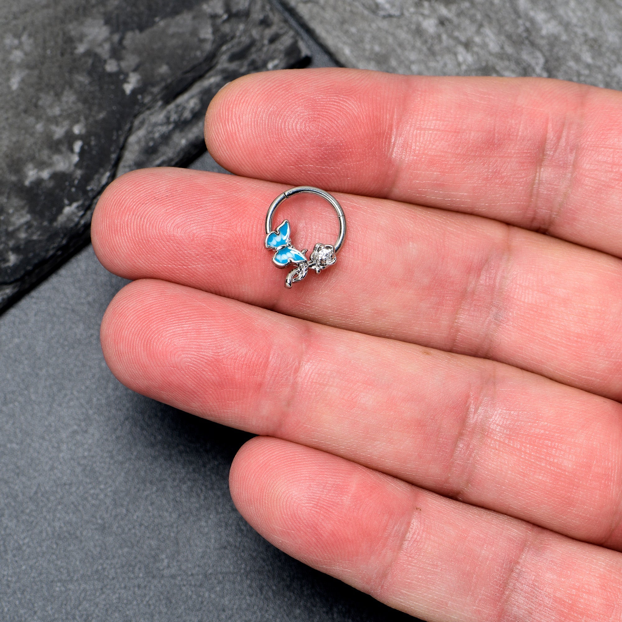 BodyCandy 16G 3/8 Clear CZ Gem Butterfly Rose Blue Hinged Segment Ring — lifestyle context